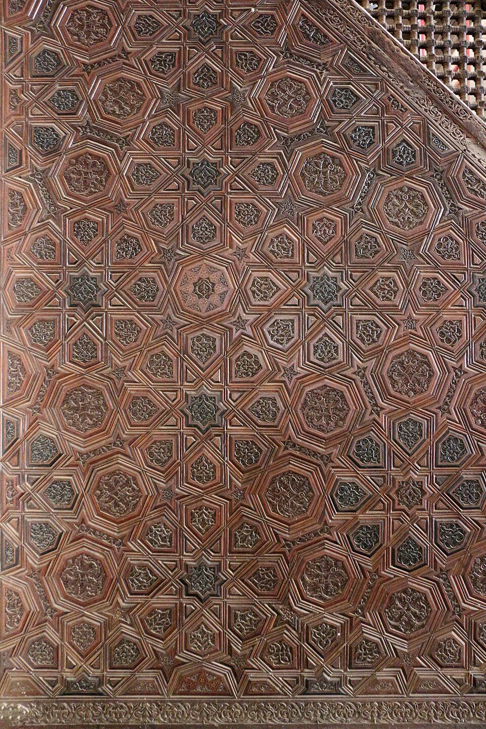 Close-up of a wooden panel with intricate geometric pattern