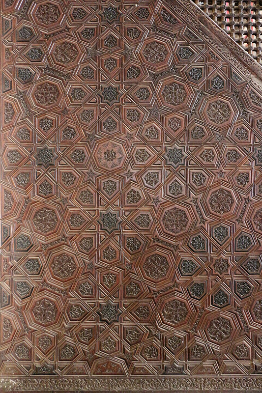 Close-up of a wooden panel with intricate geometric pattern